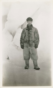 Image: Donald B. MacMillan in fur suit, between icebergs